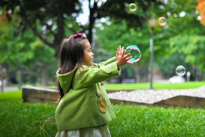 child playing with a bubble
