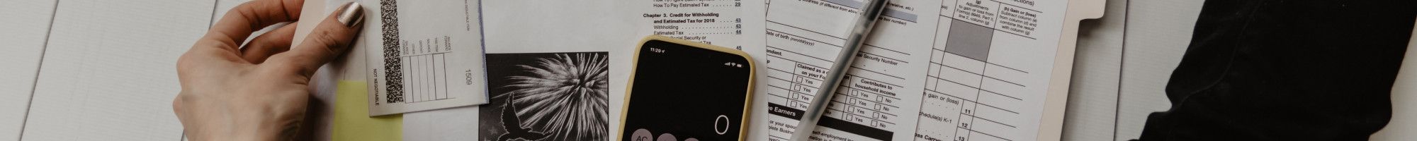 forms and documents on the floor with a calculator