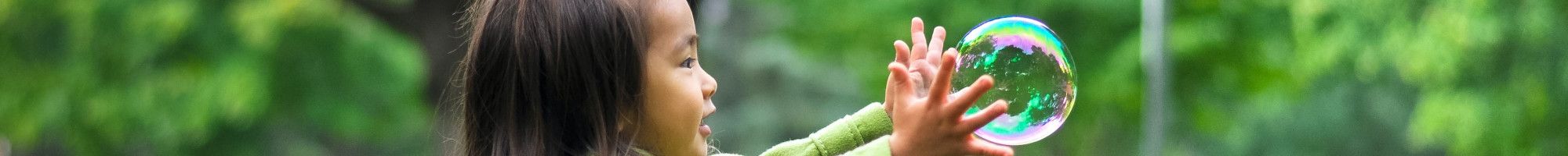 child playing with a bubble