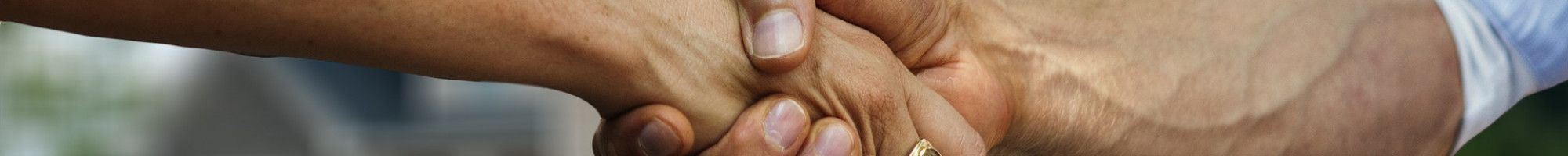 handshake in front of a house